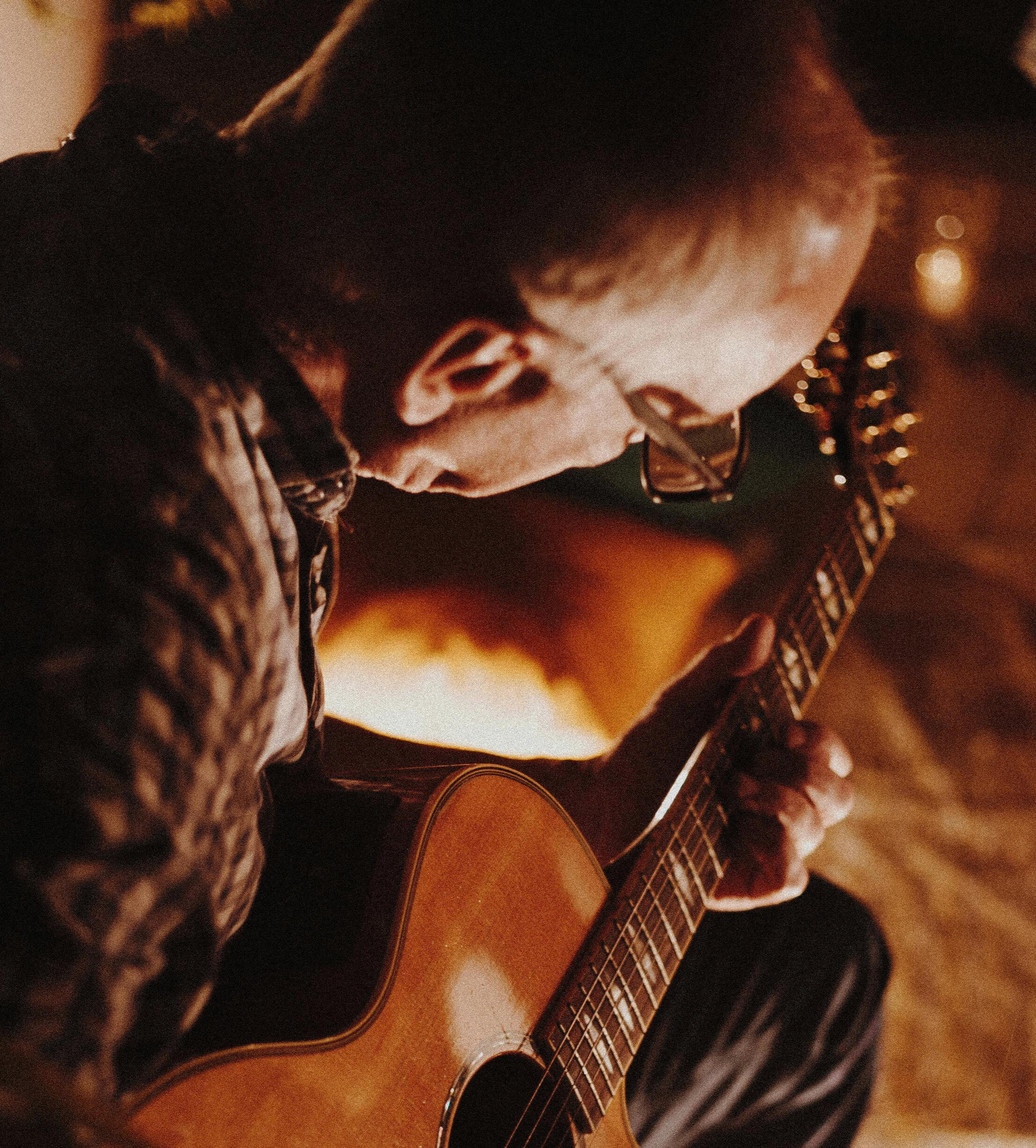 Older man playing an acoustic guitar Photo by Edward Eyer: https://www.pexels.com/photo/photo-of-man-playing-guitar-1587284/