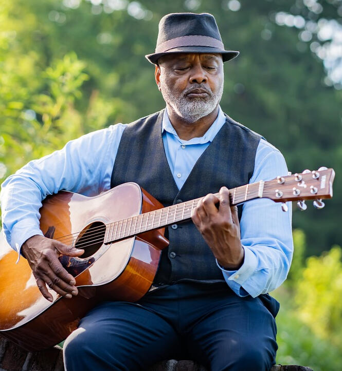 Older male playing guitar